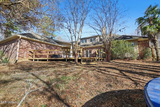 rear view of house featuring a deck