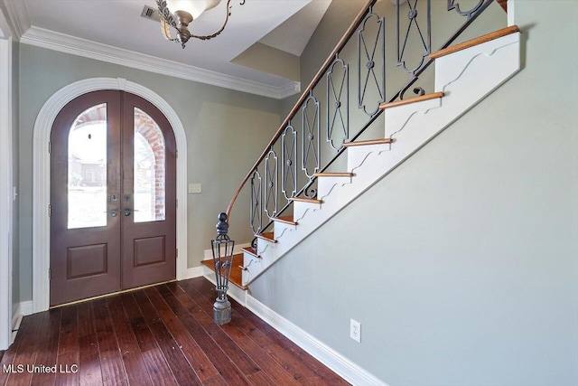 foyer with dark hardwood / wood-style flooring, french doors, and ornamental molding