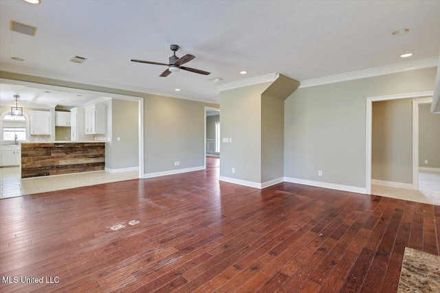 unfurnished living room with hardwood / wood-style flooring, ceiling fan, ornamental molding, and sink