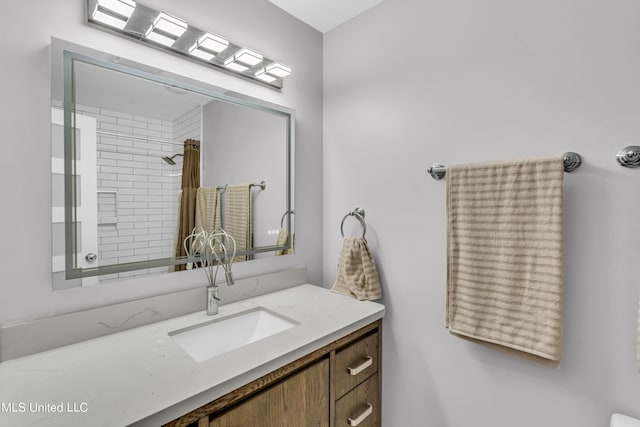 bathroom featuring vanity and tiled shower