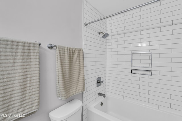 bathroom featuring toilet and tiled shower / bath combo