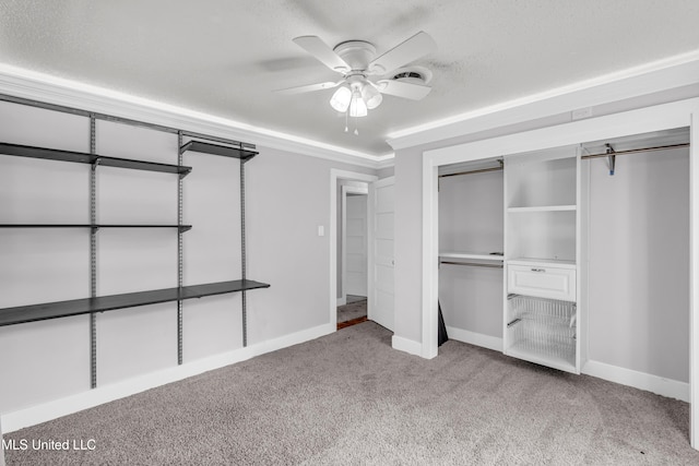 unfurnished bedroom with a closet, a textured ceiling, carpet, and ceiling fan