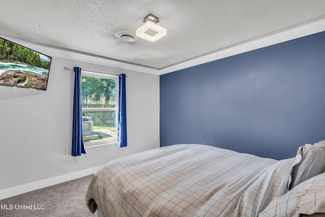 bedroom with ornamental molding, a textured ceiling, and carpet floors