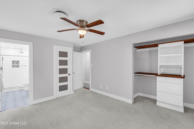 unfurnished bedroom with light colored carpet, a closet, and ceiling fan