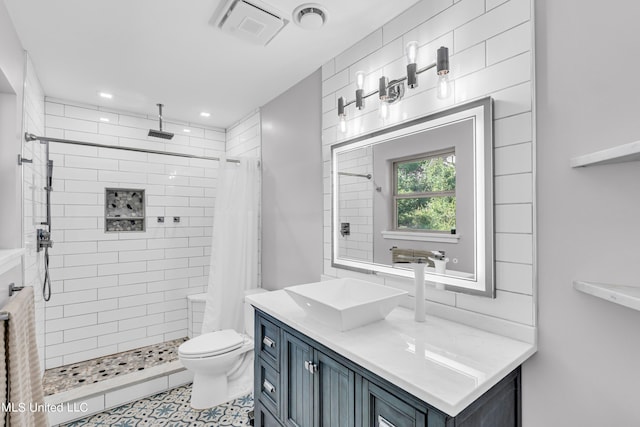 bathroom featuring toilet, walk in shower, vanity, and tile patterned flooring