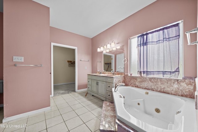 224 Clarence Ave, Pass Christian, MS 39571 - full bath featuring baseboards, vanity, a whirlpool tub, and tile patterned floors