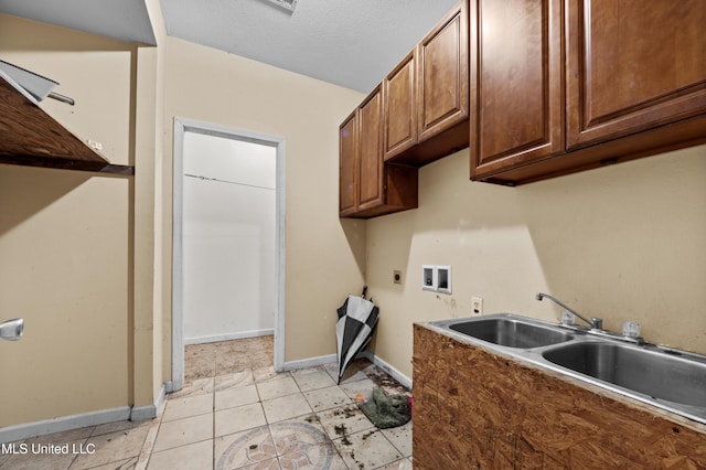 224 Clarence Ave, Pass Christian, MS 39571 - clothes washing area with hookup for an electric dryer, hookup for a washing machine, cabinet space, baseboards, and light tile patterned floors