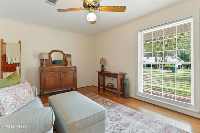 2508 Orrell Dr, Gautier, MS 39553 - living room featuring plenty of natural light, ornamental molding, wood finished floors, and a ceiling fan