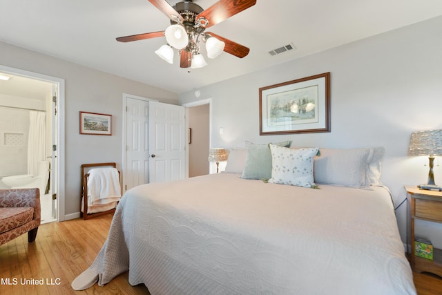 2508 Orrell Dr, Gautier, MS 39553 - bedroom featuring light wood-style flooring, ceiling fan, connected bathroom, and baseboards