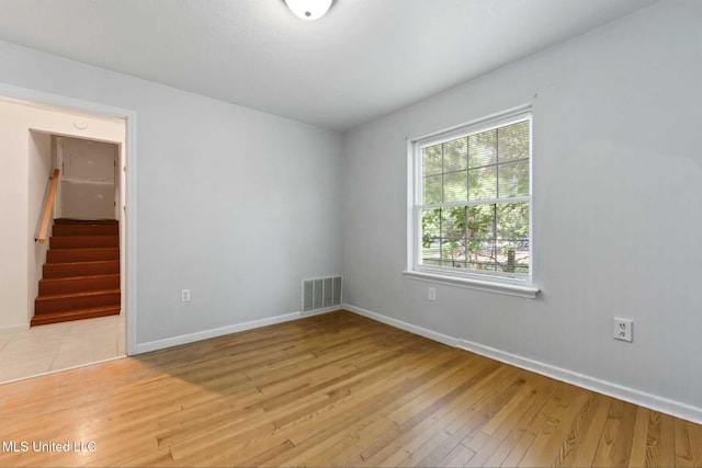 2508 Orrell Dr, Gautier, MS 39553 - spare room with light wood-style flooring, baseboards, and stairs