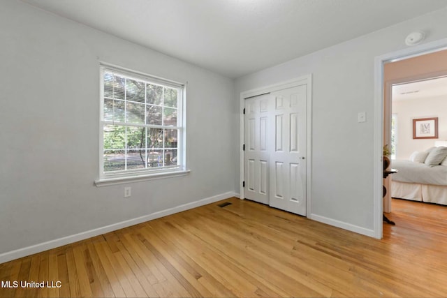 2508 Orrell Dr, Gautier, MS 39553 - unfurnished bedroom with light wood-type flooring, baseboards, and a closet