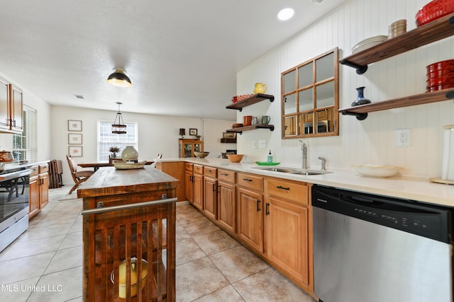 2508 Orrell Dr, Gautier, MS 39553 - kitchen with appliances with stainless steel finishes, open shelves, a sink, light tile patterned flooring, and a kitchen island