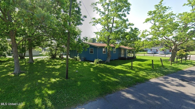 view of side of home with a lawn