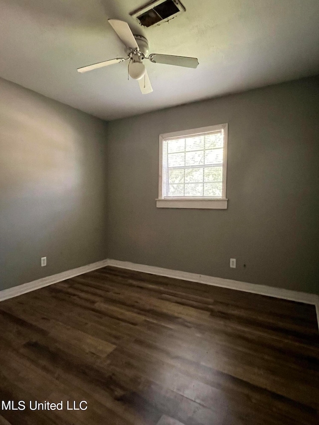 unfurnished room featuring ceiling fan and dark wood-type flooring