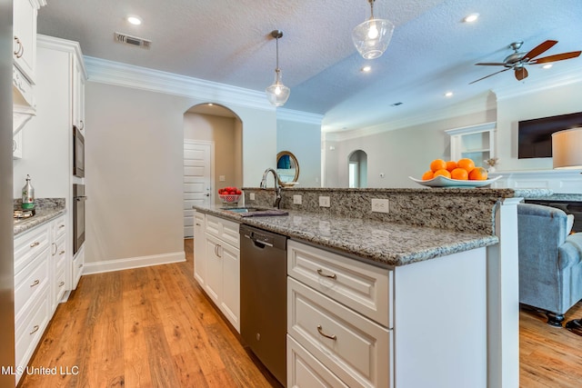 kitchen with dishwashing machine, sink, hanging light fixtures, a textured ceiling, and white cabinets