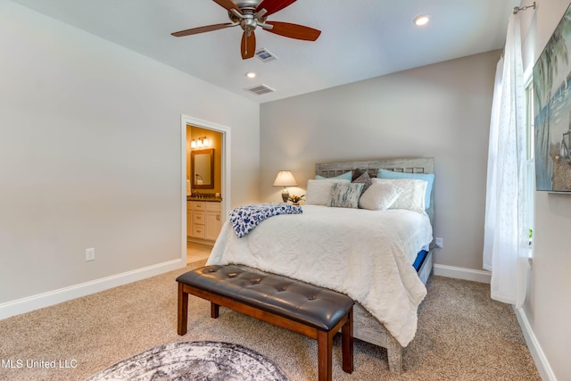 bedroom with ceiling fan, connected bathroom, and carpet floors