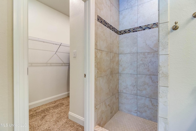 bathroom with tiled shower