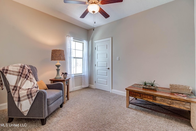 living area with light colored carpet and ceiling fan