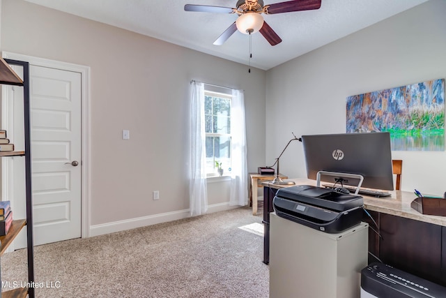 carpeted office space with ceiling fan