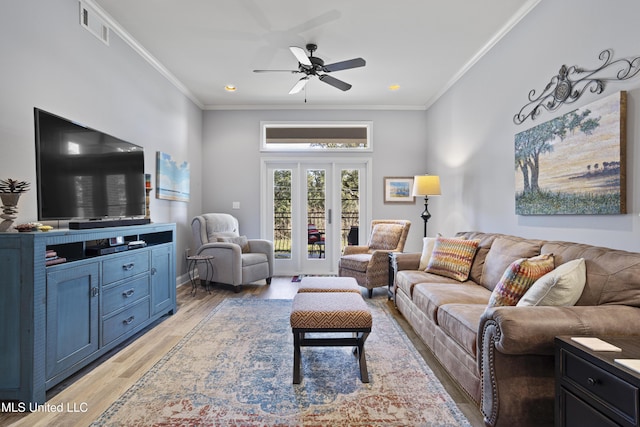 living room featuring ceiling fan, french doors, crown molding, and light hardwood / wood-style flooring