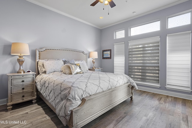 bedroom with dark hardwood / wood-style flooring, ceiling fan, and ornamental molding