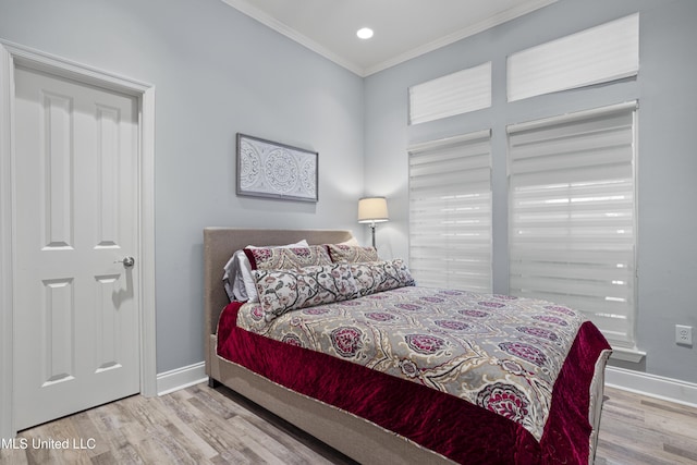 bedroom featuring light wood-type flooring and ornamental molding