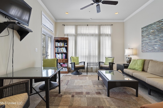 living room featuring a wealth of natural light, crown molding, and ceiling fan