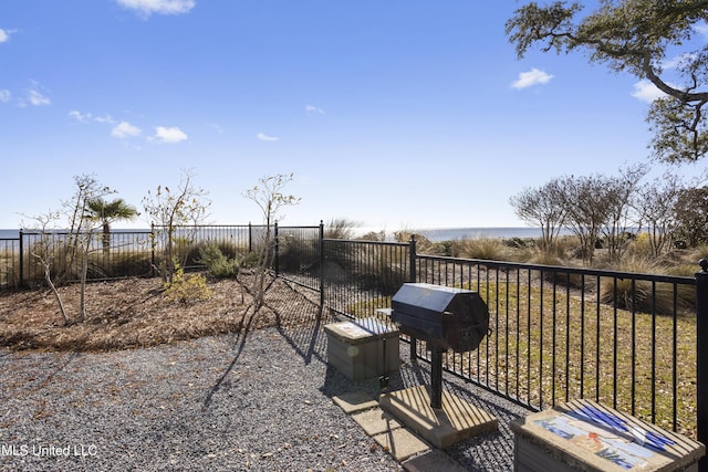 view of patio / terrace featuring a water view and grilling area