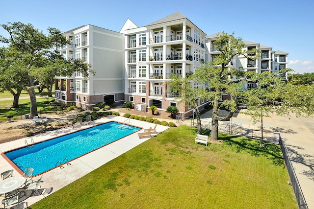 view of pool featuring a lawn and a patio area