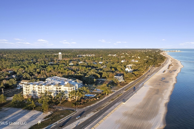 birds eye view of property featuring a water view and a beach view