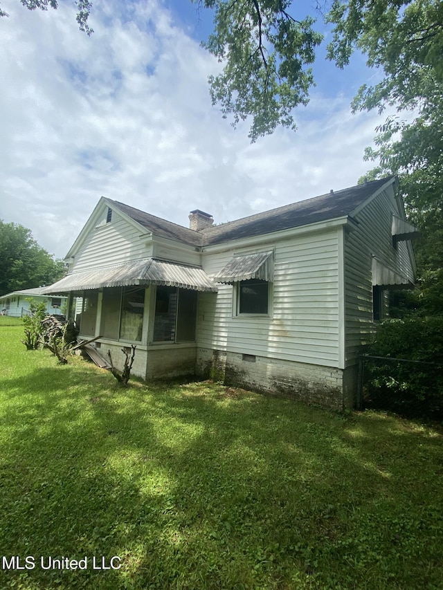 210 Colonial Cir, Jackson, MS 39211 - back of property with a lawn and a chimney