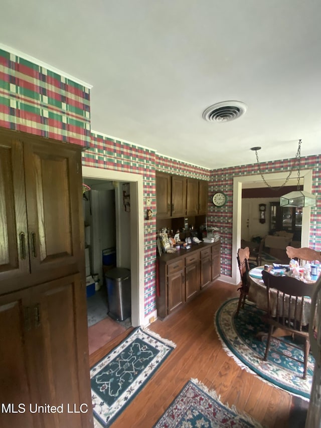 210 Colonial Cir, Jackson, MS 39211 - dining space with wallpapered walls and dark wood-type flooring
