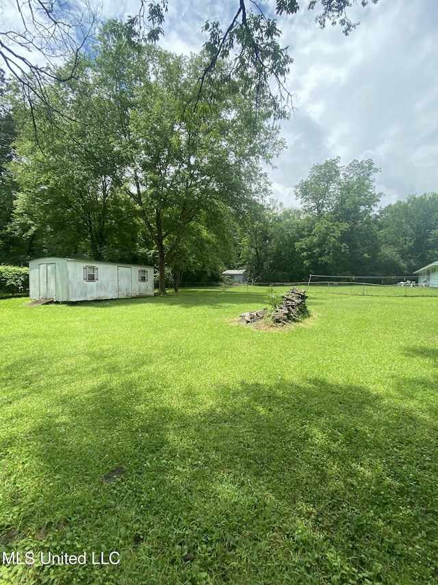 210 Colonial Cir, Jackson, MS 39211 - view of grassy yard with an outbuilding