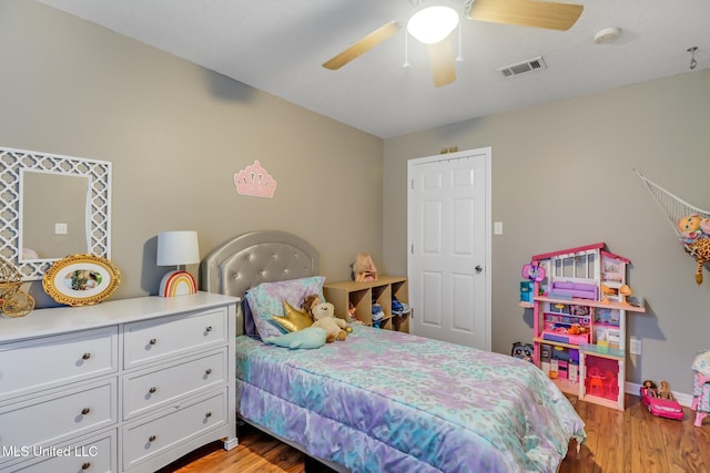 bedroom with a ceiling fan, baseboards, visible vents, and light wood-type flooring