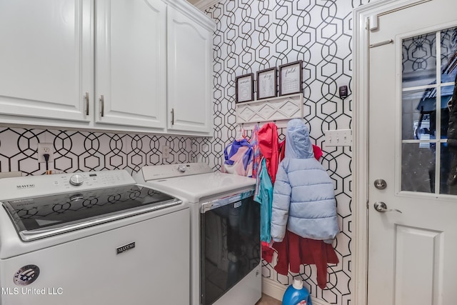 clothes washing area with washer and clothes dryer and cabinet space