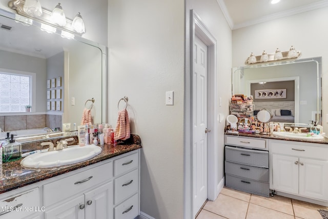 bathroom featuring visible vents, vanity, crown molding, and tile patterned flooring