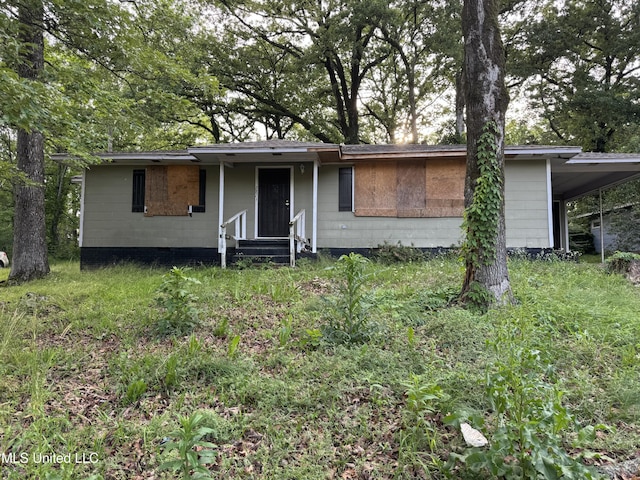 ranch-style home featuring an attached carport, entry steps, and crawl space