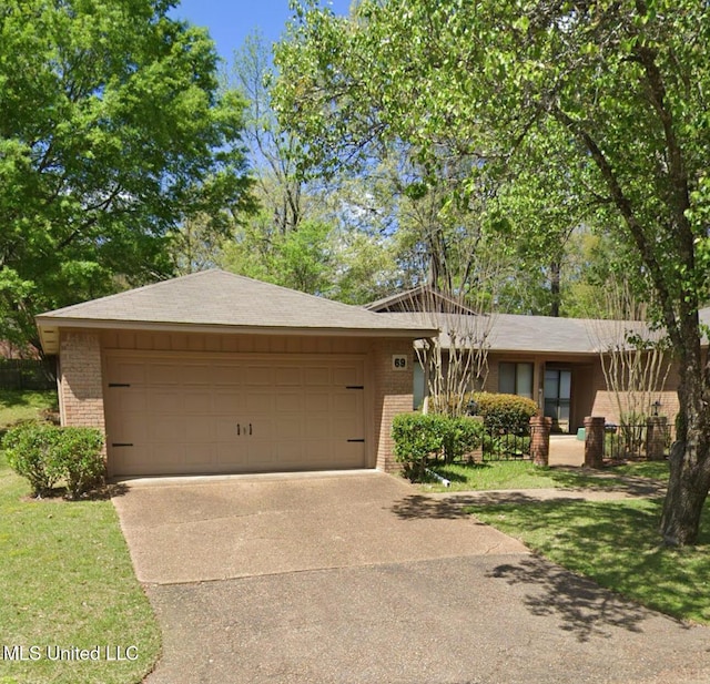 view of front of house featuring driveway, an attached garage, and brick siding