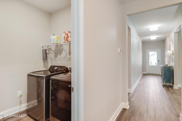 87139 Highpoint Dr, Diamondhead, MS 39525 - laundry room with independent washer and dryer and wood finished floors