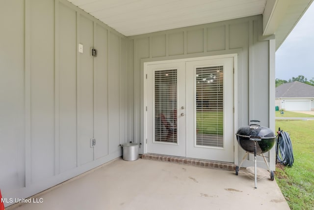 87139 Highpoint Dr, Diamondhead, MS 39525 - doorway to property featuring board and batten siding, a patio, and french doors