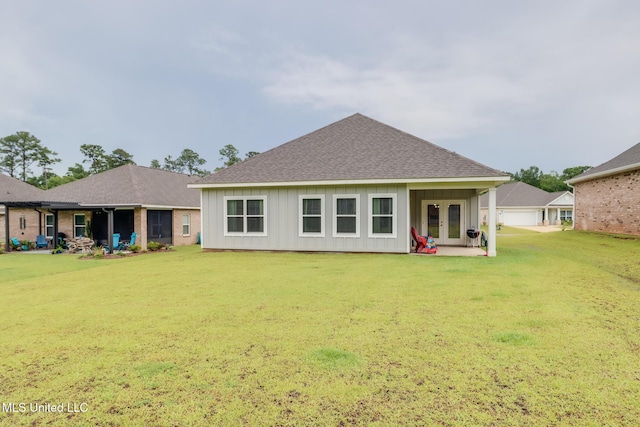 87139 Highpoint Dr, Diamondhead, MS 39525 - back of property with french doors, a shingled roof, a lawn, and a detached garage