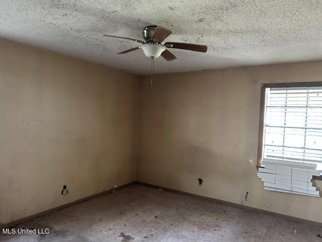 2728 Dogwood Ln, Moss Point, MS 39562 - empty room with baseboards, a textured ceiling, and a ceiling fan