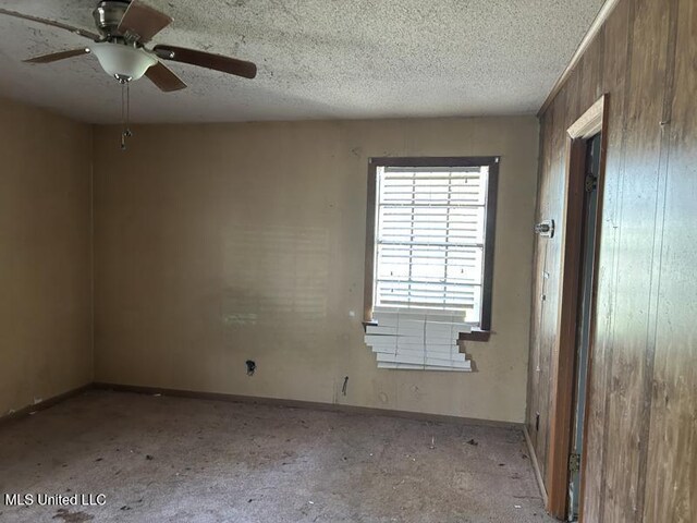2728 Dogwood Ln, Moss Point, MS 39562 - unfurnished room featuring ceiling fan, baseboards, and a textured ceiling