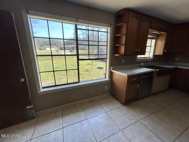 2728 Dogwood Ln, Moss Point, MS 39562 - kitchen featuring light tile patterned floors, open shelves, baseboards, and a sink
