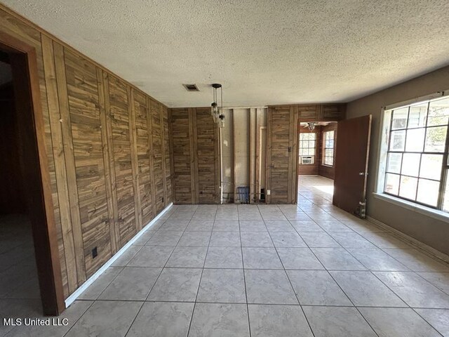 2728 Dogwood Ln, Moss Point, MS 39562 - empty room featuring visible vents, a ceiling fan, a textured ceiling, light tile patterned floors, and baseboards