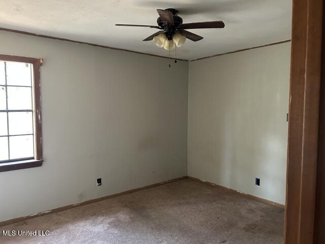 2728 Dogwood Ln, Moss Point, MS 39562 - empty room with carpet flooring, a healthy amount of sunlight, baseboards, and ceiling fan