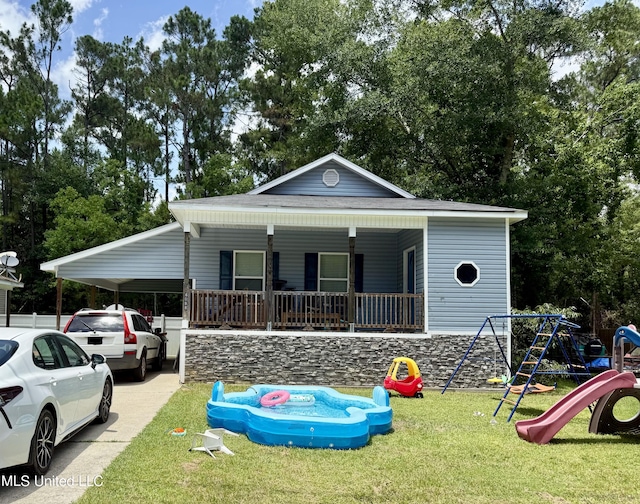 6088 E Hinds St, Bay Saint Louis, MS 39520 - view of front of home featuring a front yard, a playground, a porch, an attached carport, and concrete driveway