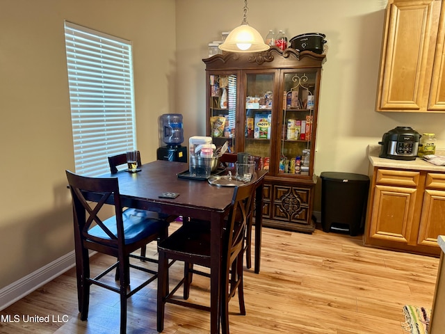 6088 E Hinds St, Bay Saint Louis, MS 39520 - dining room with light wood-style flooring and baseboards