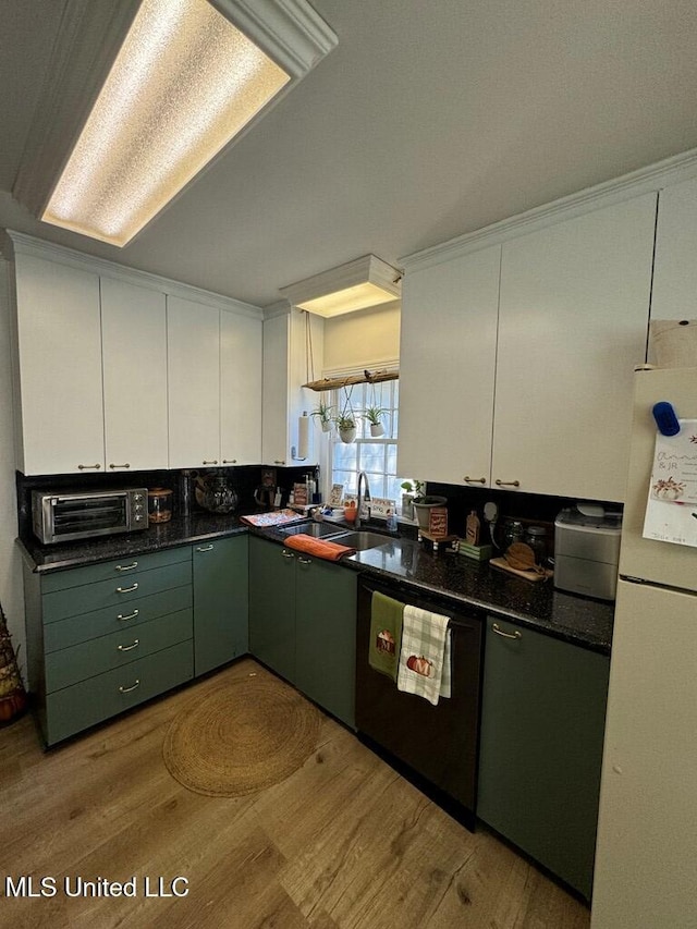 kitchen with white cabinets, white fridge, stainless steel dishwasher, and sink