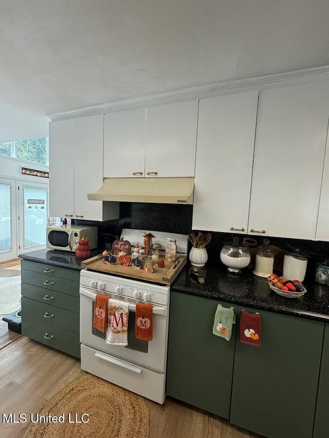 kitchen with light hardwood / wood-style floors, white cabinetry, and white appliances